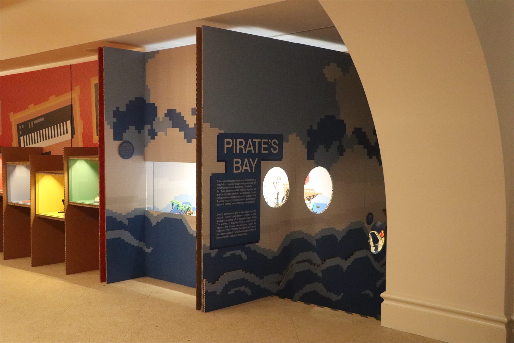 The entrance to Pirate&rsquo;s Bay, with lit portholes in a blue wall