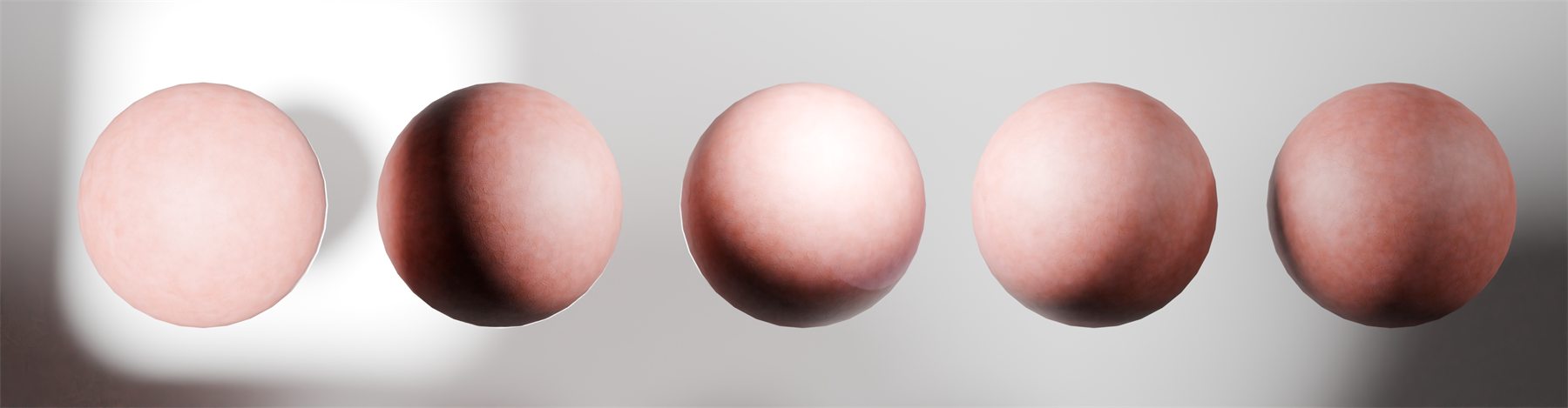 Five test spheres in a row, each carrying a further stage of the skin material