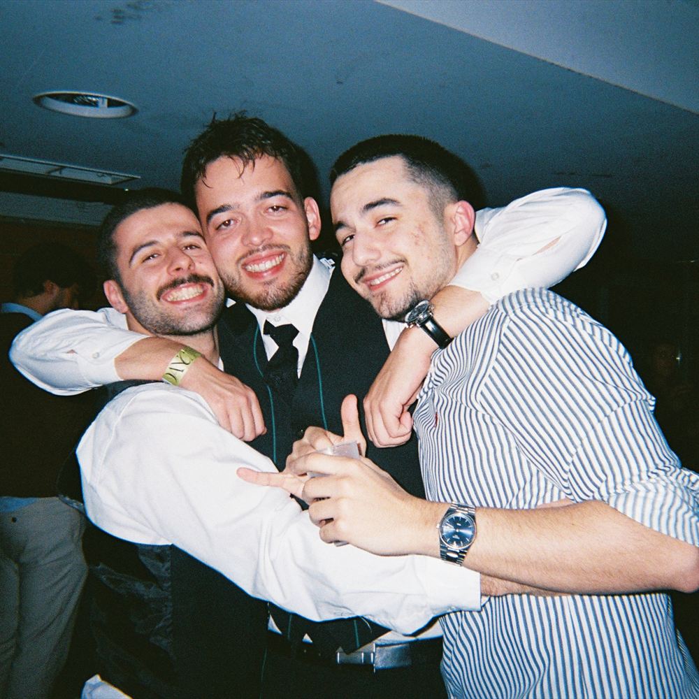 Two friends with their arms around each other at an event