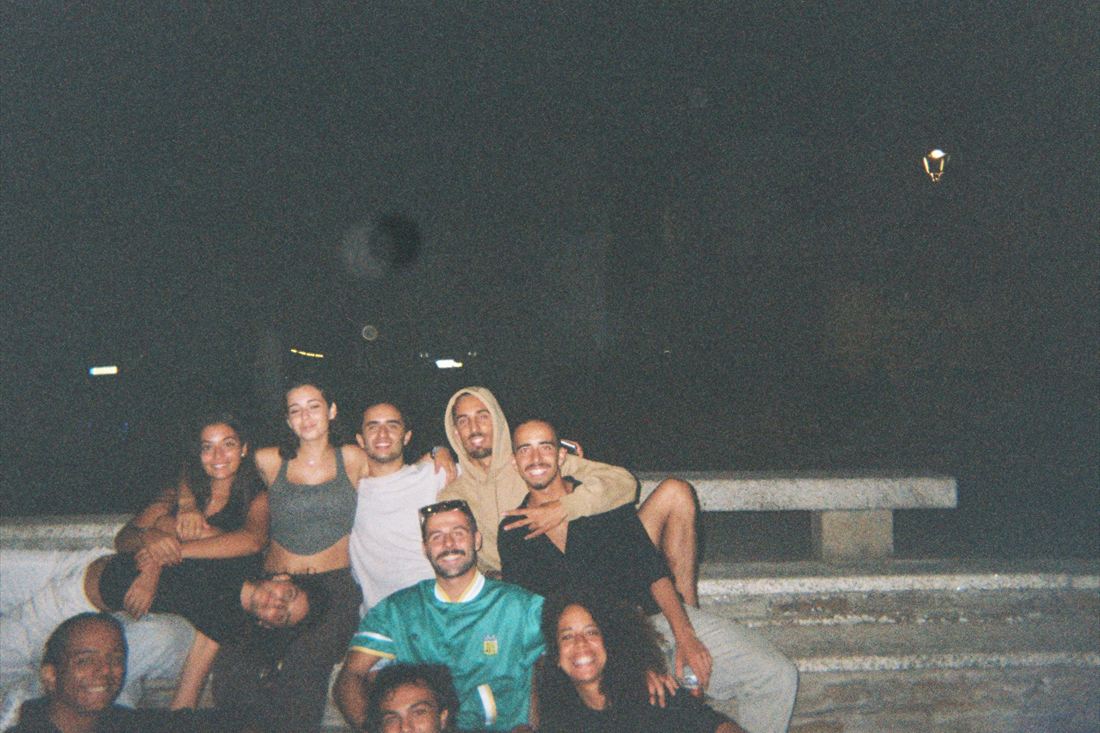 A group sitting together outdoors at night