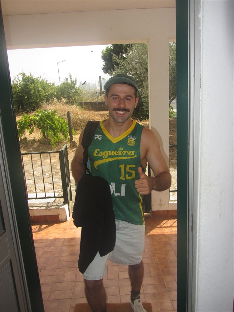 Standing in a doorway in a green Esgueira basketball shirt, number 15