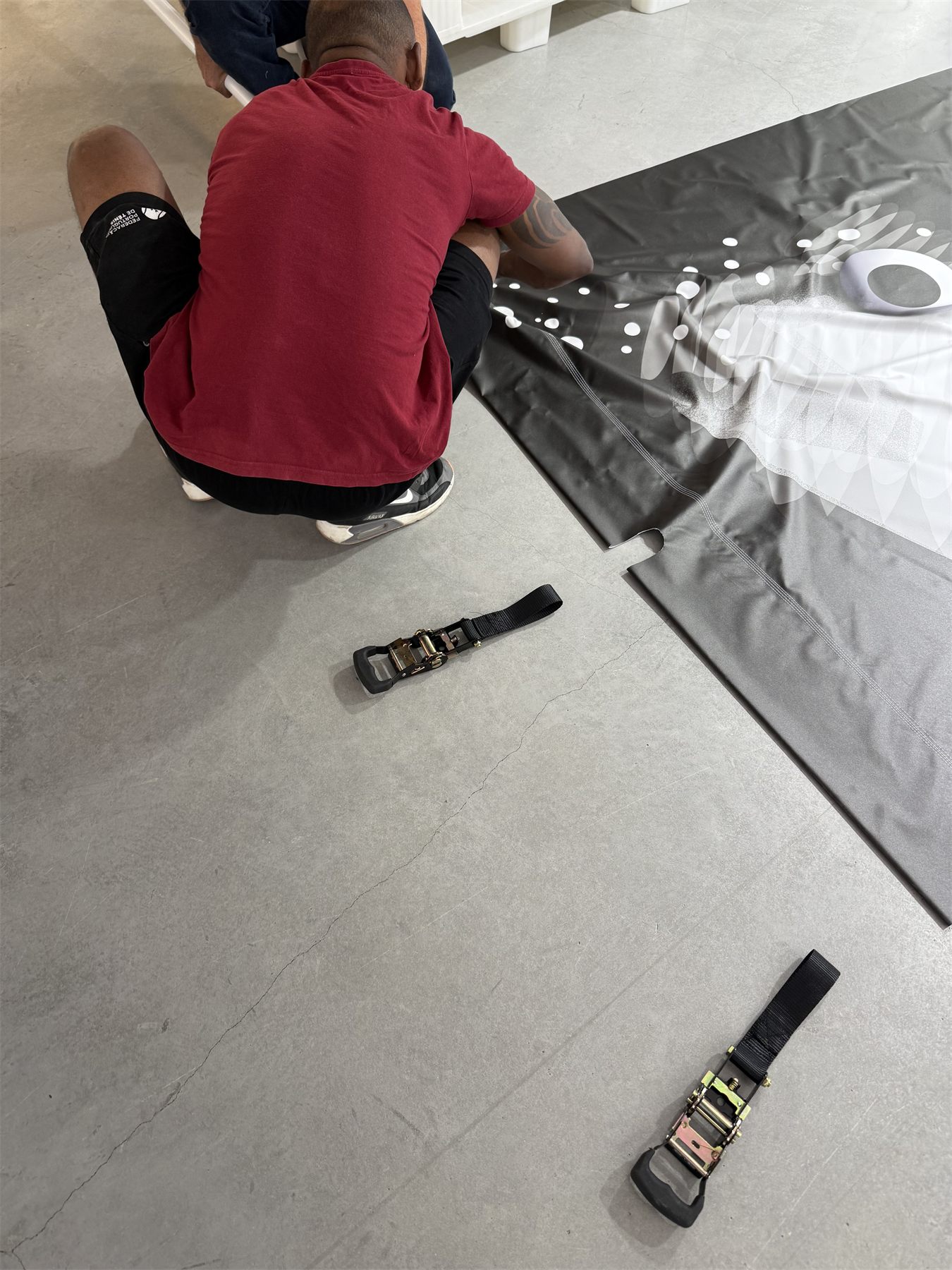A steel tube being threaded through the sewn sleeve along the edge of the fabric